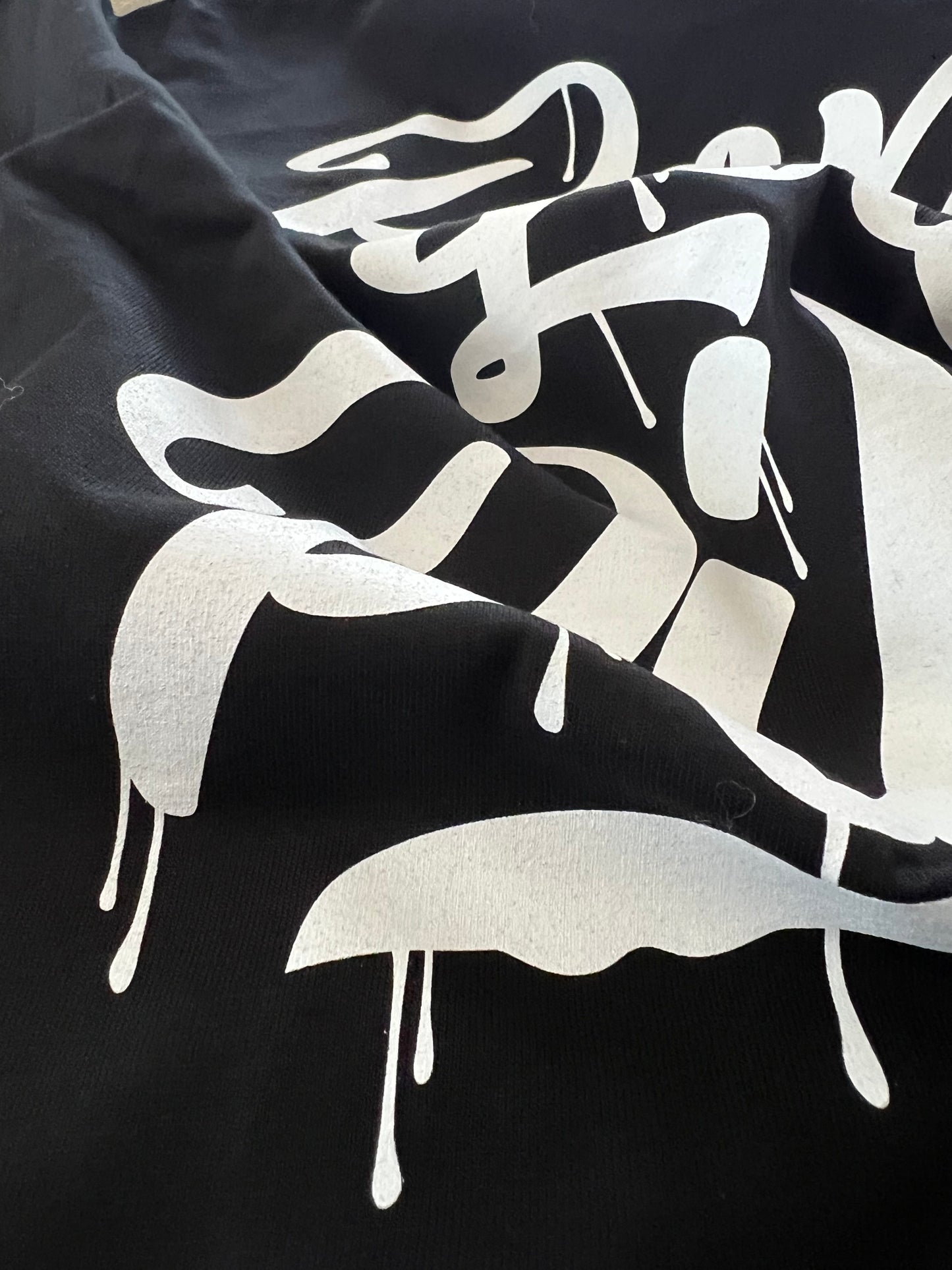 Black Pilas Clothing Co. PLP Drip t-shirt with white graffiti-style 'Ponte Las Pilas' lettering and paint drip design - Latino inspirational clothing