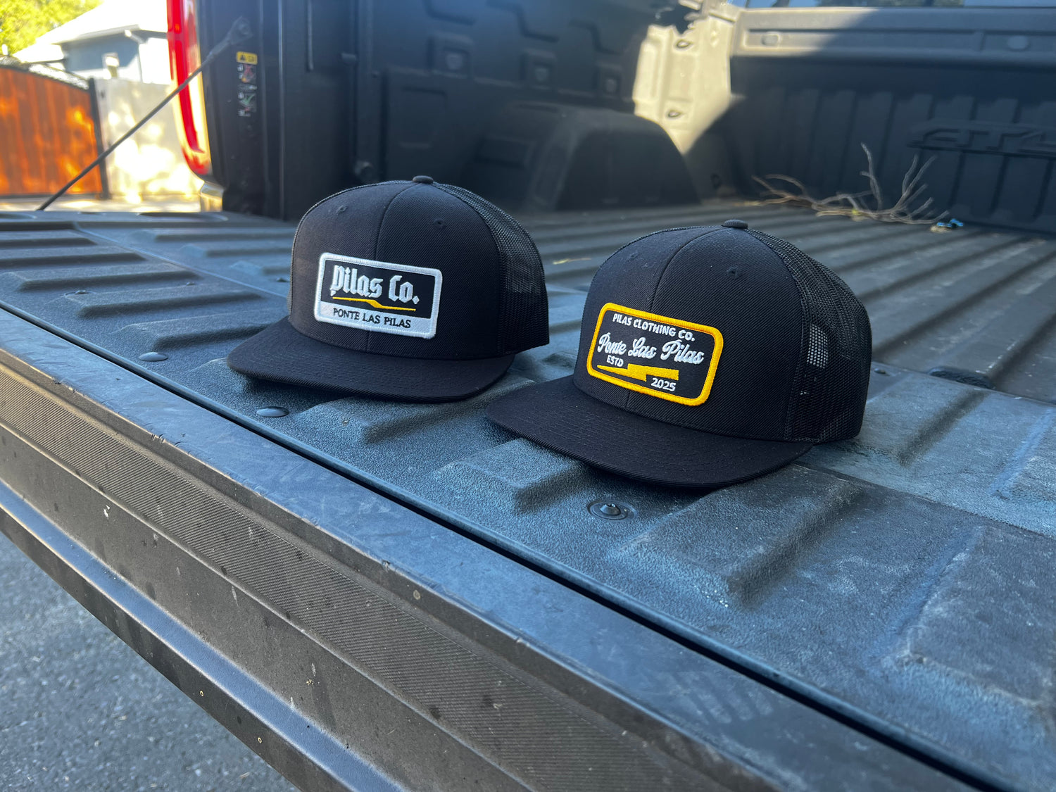 Pilas Co trucker hats in pickup truck - Latino workwear brand snapback caps for construction workers