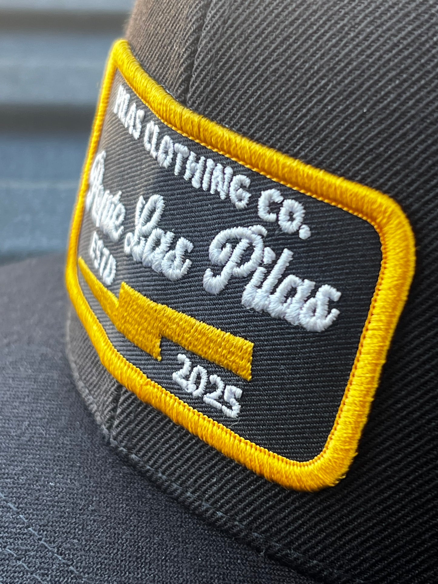 Pilas Clothing Co embroidered patch close-up - Ponte Las Pilas 2025 trucker hat badge detail