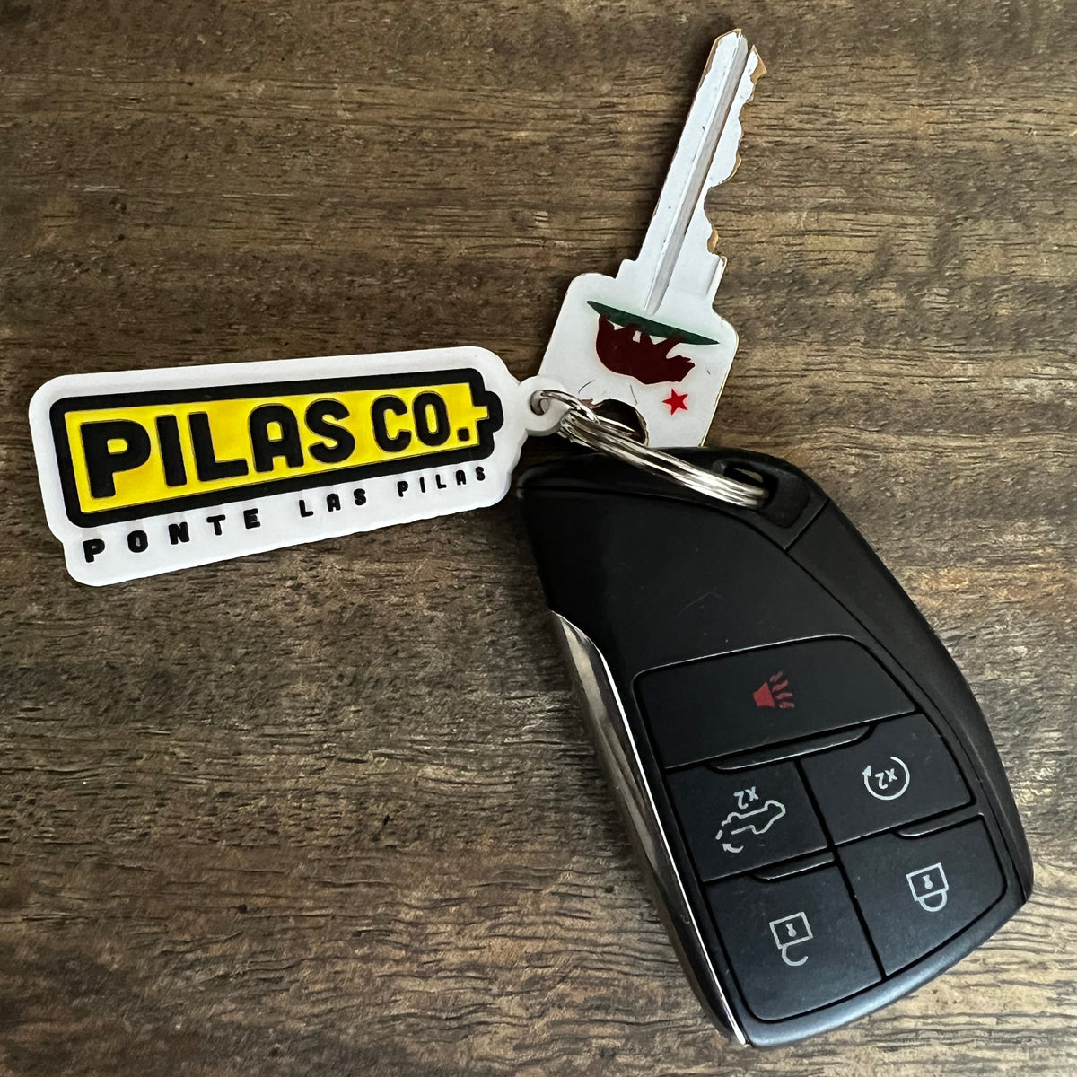 Pilas Co Ponte Las Pilas battery keychain - Latino workwear brand accessories