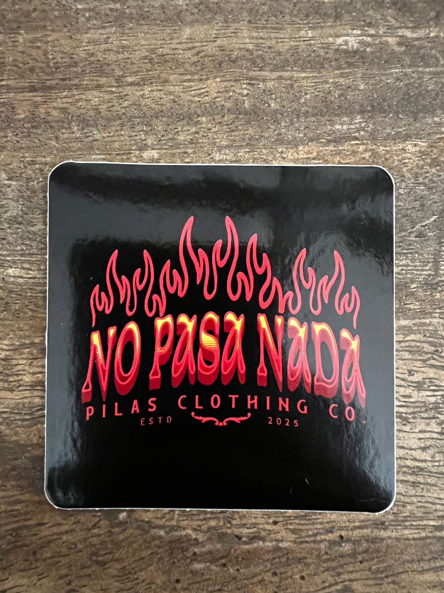 Pilas Clothing Co No Pasa Nada sticker - Latino motivational decal with flames design