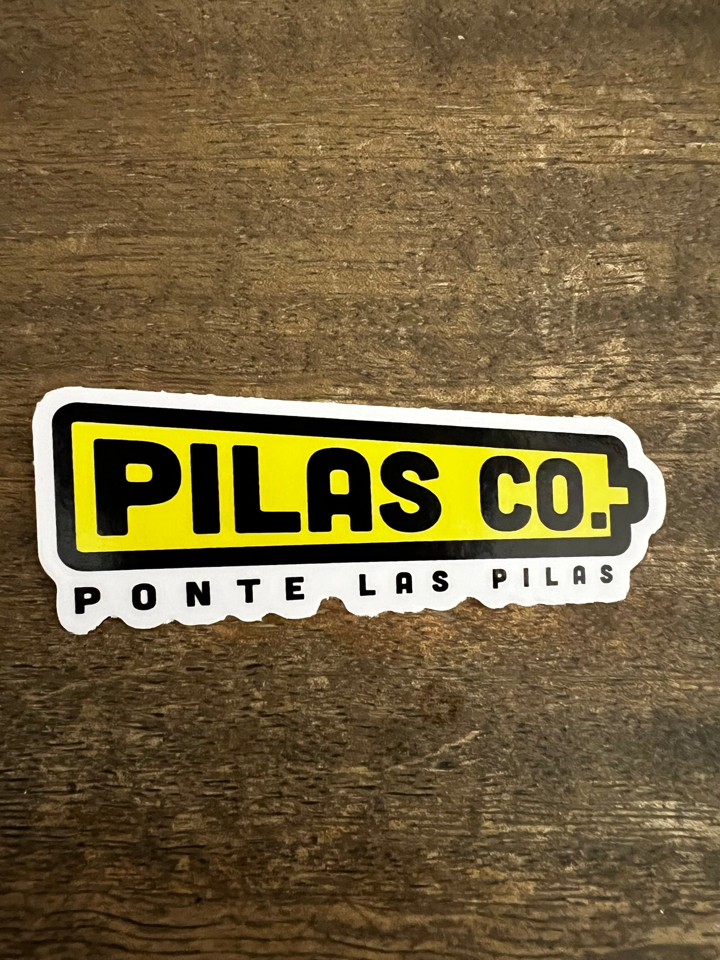 Pilas Co Ponte las Pilas yellow battery sticker - Latino workwear brand motivational decal