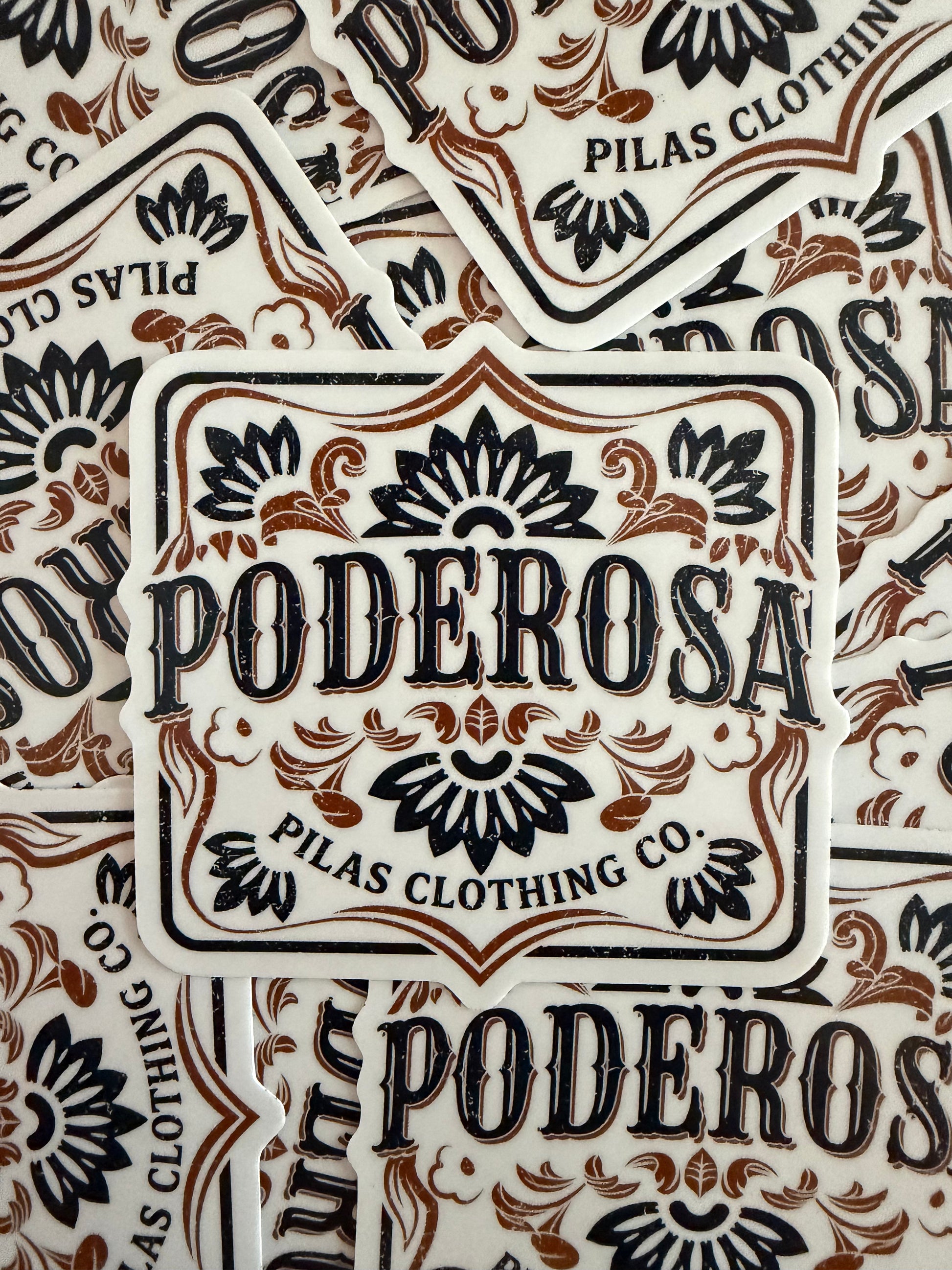 Stack of 3.5 inch Poderosa die-cut vinyl stickers featuring bold western lettering and hand-drawn Talavera floral design, by Pilas Clothing Co.