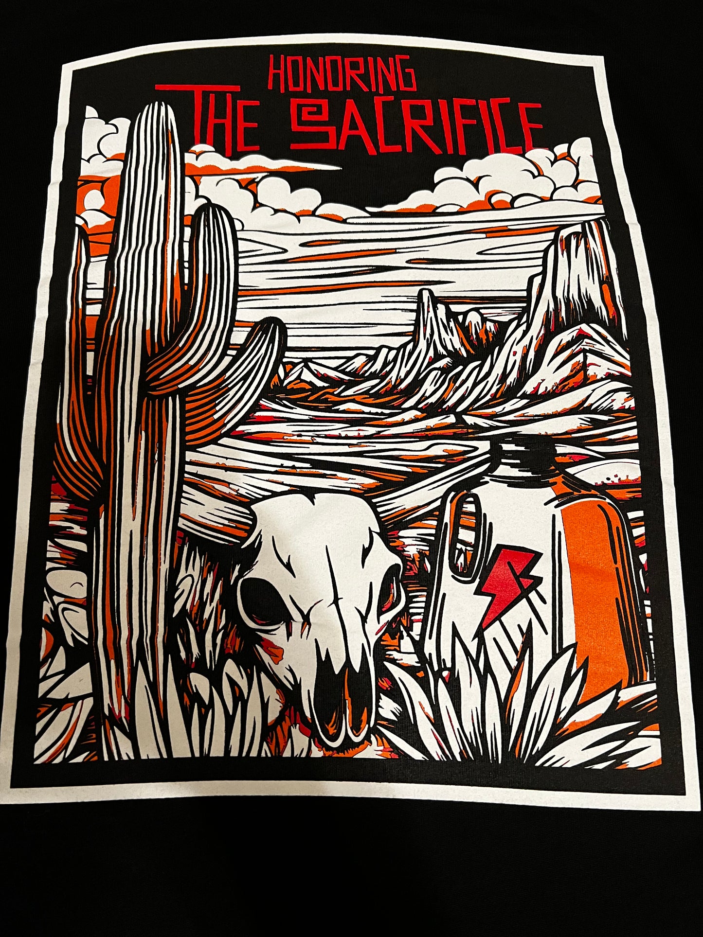 Honoring the Sacrifice back design - Mexican heritage shirt featuring desert landscape with cactus, cow skull, and gallon jug artwork representing immigrant journey
