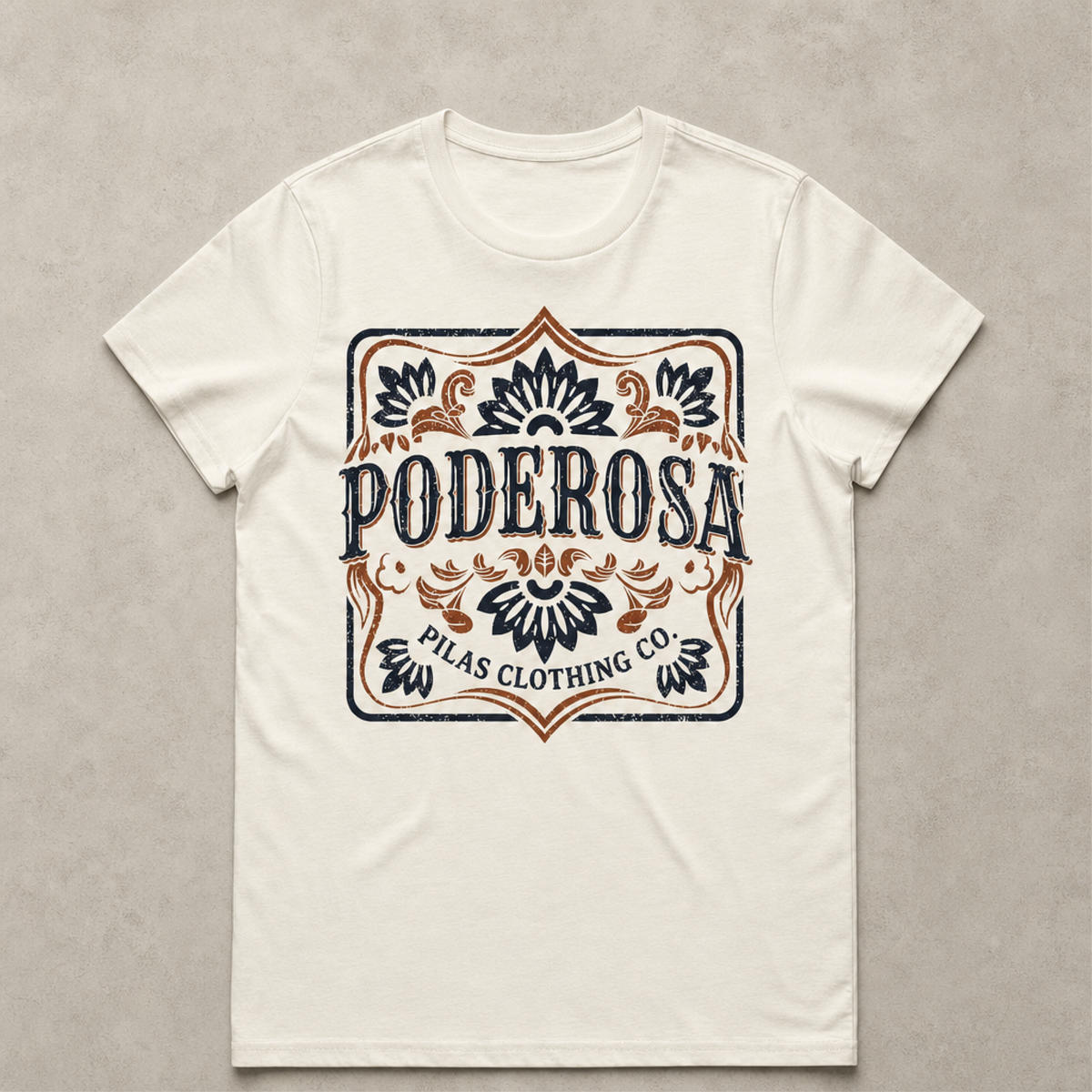 An off-white short-sleeve crewneck t-shirt with a vintage-style graphic print on the front. The graphic features the word 'PODEROSA' in dark navy blue lettering, surrounded by ornate flourishes in a warm brown/copper tone and outlined in dark navy.